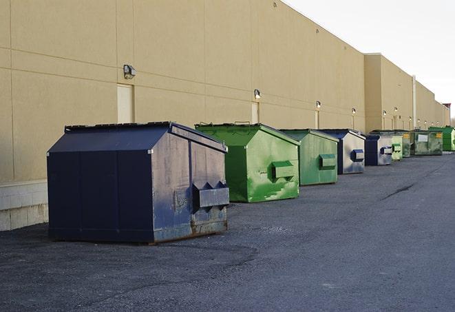 construction debris being dumped into dumpsters in Angelus Oaks, CA